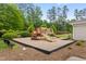Community playground with slides and climbing structure nestled among mature trees and landscaping at 324 Providence Glen Dr, Chapel Hill, NC 27514