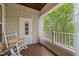Cozy porch featuring a rocking chair, wood flooring, and a view of the surrounding greenery at 324 Providence Glen Dr, Chapel Hill, NC 27514