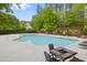 Large community pool with ample deck space and seating, surrounded by lush trees and landscaping at 324 Providence Glen Dr, Chapel Hill, NC 27514