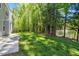 Serene backyard overlooking a pond with a fountain, lush trees, and a patio space at 3411 Massey Pond Trl, Raleigh, NC 27616