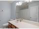 Well-lit bathroom featuring a large mirror, toilet, and vanity with a sink and storage at 3411 Massey Pond Trl, Raleigh, NC 27616