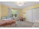 Inviting bedroom with a bed, window, desk area, closet, and neutral decor at 3411 Massey Pond Trl, Raleigh, NC 27616