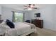 Spacious bedroom with a ceiling fan, a window overlooking the backyard, and a dresser at 3411 Massey Pond Trl, Raleigh, NC 27616