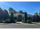 Exterior shot of the community clubhouse entrance framed by landscaping and lush, mature trees at 3411 Massey Pond Trl, Raleigh, NC 27616