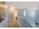 Upstairs hallway with light blue walls, carpet, white trim and doors leading to rooms and bath at 3411 Massey Pond Trl, Raleigh, NC 27616