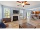 Spacious living room with fireplace, flat-screen TV, and access to the dining area and backyard through sliding glass doors at 3411 Massey Pond Trl, Raleigh, NC 27616