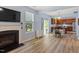 Living room with fireplace, flat-screen TV and view to the dining area and kitchen at 3411 Massey Pond Trl, Raleigh, NC 27616