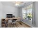 Bright home office with a large window, neutral walls, and desk area with a rolling chair at 3411 Massey Pond Trl, Raleigh, NC 27616
