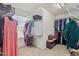 Spacious walk-in closet with ample shelving, hanging rods, and a bench for storage solutions at 3411 Massey Pond Trl, Raleigh, NC 27616
