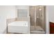 Bathroom featuring soaking tub and glass enclosed shower with tile surround at 3513 Diamond Springs Dr, Raleigh, NC 27610