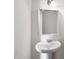 Bathroom featuring pedestal sink, decorative mirror, and sconce lighting at 3513 Diamond Springs Dr, Raleigh, NC 27610