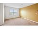 Spacious bedroom featuring neutral carpet, a window, and contrasting paint at 3513 Diamond Springs Dr, Raleigh, NC 27610