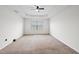 Large bedroom with neutral carpet, a window, and modern ceiling fan at 3513 Diamond Springs Dr, Raleigh, NC 27610