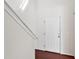 Bright entryway featuring hardwood floors, a white door, and access to a staircase with white trim at 3513 Diamond Springs Dr, Raleigh, NC 27610