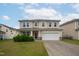 Charming two-story home with a well-maintained lawn, attached two-car garage, and welcoming front porch at 3513 Diamond Springs Dr, Raleigh, NC 27610