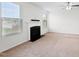 A bright living room featuring a fireplace, ceiling fan, carpet flooring, and a window at 3513 Diamond Springs Dr, Raleigh, NC 27610