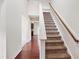 Open staircase leading to second story features a hallway and cherry hardwood floors at 3513 Diamond Springs Dr, Raleigh, NC 27610