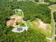 Aerial view of a secluded property featuring two ponds, additional structure, and long private driveway at 3704 Hesters Store Rd, Hurdle Mills, NC 27541