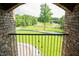 A stunning backyard view from a brick archway showcasing lush greenery and a long driveway at 3704 Hesters Store Rd, Hurdle Mills, NC 27541