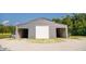 Large gray barn with three bays and gravel parking provides ample space for equipment or storage at 3704 Hesters Store Rd, Hurdle Mills, NC 27541