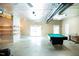 Finished basement offers a pool table, seating area, and access to the outside at 3704 Hesters Store Rd, Hurdle Mills, NC 27541