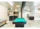 Large finished basement with a pool table, bar, shelving, and seating area at 3704 Hesters Store Rd, Hurdle Mills, NC 27541