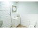 A tiled bathroom offers a sink and vanity and a toilet with textured brick walls at 3704 Hesters Store Rd, Hurdle Mills, NC 27541