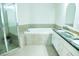 Bathroom featuring a glass shower, dual sinks with granite counters, and a soaking tub at 3704 Hesters Store Rd, Hurdle Mills, NC 27541