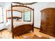 A bedroom featuring a wooden canopy bed and an armoire at 3704 Hesters Store Rd, Hurdle Mills, NC 27541