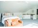 Cozy bedroom with a lounge area, plush carpeting, wet bar, ceiling fan, and natural light at 3704 Hesters Store Rd, Hurdle Mills, NC 27541