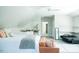 Bright bedroom with a white ceiling fan, grey carpet, bed, and a lounge chair at 3704 Hesters Store Rd, Hurdle Mills, NC 27541