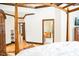 A bedroom featuring a wooden canopy bed and hardwood floors at 3704 Hesters Store Rd, Hurdle Mills, NC 27541