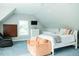 Bright bedroom featuring a television, a white ceiling fan, and a brown leather chair at 3704 Hesters Store Rd, Hurdle Mills, NC 27541