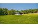 Carport in a grassy field, offering vehicle protection and outdoor charm at 3704 Hesters Store Rd, Hurdle Mills, NC 27541