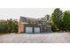 Rear exterior elevation featuring a brick exterior, two car garage, and plenty of parking at 3704 Hesters Store Rd, Hurdle Mills, NC 27541