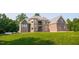 Attractive home with brick and stone exterior, balcony, and well-kept lawn, blending elegance and comfort at 3704 Hesters Store Rd, Hurdle Mills, NC 27541