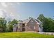 Close up of a brick home with stone accents, showcasing architectural details and quality craftsmanship at 3704 Hesters Store Rd, Hurdle Mills, NC 27541