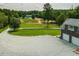 Beautiful home featuring a long driveway, brick exterior, attached garage, and expansive front yard with pond at 3704 Hesters Store Rd, Hurdle Mills, NC 27541