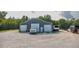 Spacious garage with three doors, offering ample storage and parking space on a gravel lot at 3704 Hesters Store Rd, Hurdle Mills, NC 27541