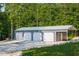 Large garage with four bays, complete with an additional space, perfect for vehicle and equipment storage at 3704 Hesters Store Rd, Hurdle Mills, NC 27541