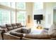 Spacious living room with a large sectional couch, bright windows, tall ceilings, and decor at 3704 Hesters Store Rd, Hurdle Mills, NC 27541