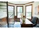 Sunlit office space featuring a spiral staircase, wood paneling, and tile flooring at 3704 Hesters Store Rd, Hurdle Mills, NC 27541
