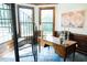 Well-lit office space featuring a spiral staircase, wood paneling, and tile flooring at 3704 Hesters Store Rd, Hurdle Mills, NC 27541