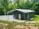 The new outbuilding features an enclosed garage with awning, additional storage, and concrete pad at 3704 Hesters Store Rd, Hurdle Mills, NC 27541