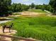 Lovely pond area features a charming donkey near lush greenery and fenced perimeter surrounding the estate at 3704 Hesters Store Rd, Hurdle Mills, NC 27541