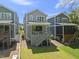 Back exterior of home featuring a deck with stairs leading to a large grassy lawn at 398 Carolina Ave, Raleigh, NC 27606