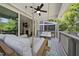 Relaxing back porch with a swing, seating area, and view into the living room at 398 Carolina Ave, Raleigh, NC 27606