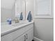 Bright and modern bathroom featuring a white vanity, sleek fixtures, and ample natural light from the window; clean and stylish at 398 Carolina Ave, Raleigh, NC 27606