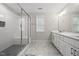 Bathroom with marble floor, glass shower, a dual sink vanity, and white tiling at 398 Carolina Ave, Raleigh, NC 27606