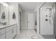 Modern bathroom with a glass enclosed shower, marble floors, and white vanity at 398 Carolina Ave, Raleigh, NC 27606